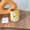 Bougie artisanale rayée orange clair en terre cuite parfum Ambre