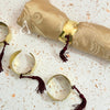 Ronds de serviette de table en laiton doré à pompons (Lot de 4)