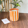 Bougie artisanale rayée orange en terre cuite parfum Fleur d'oranger