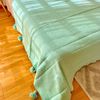 Plaid artisanal à pompons turquoise liseré argenté 2,80m x 2,00m
